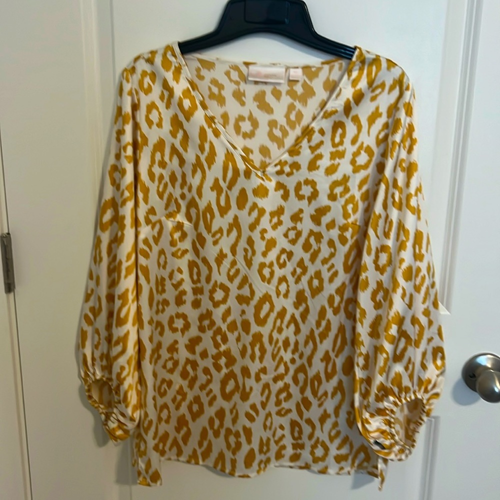 Giraffe print blouse made out of silk.
